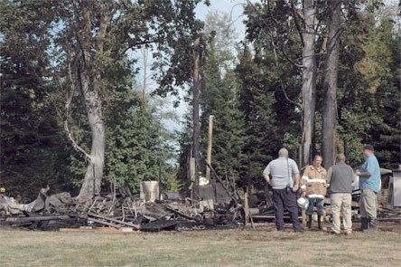 Marysville firefighters survey the scene of an Aug. 28 fire in the 5100 block of Seventh Avenue NE in Tulalip.