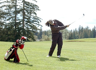 Junior Stasia Ashley chips the ball on the ninth hole at Cedarcrest Golf Course.