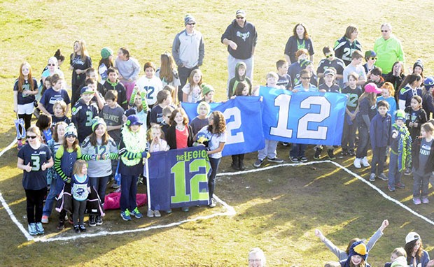 About 525 students from Pinewood Elementary assemble the number 12 on the east side of the campus.