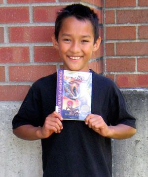 Luis Lopez proudly holds the book that he won