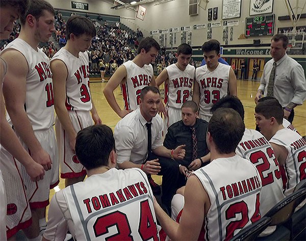 M-P coach Bary Gould talks defense with his team during a timeout with just seconds remaining in the game against Arlington.
