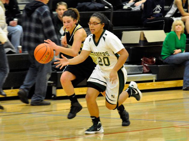 Marysville Getchell junior guard Kayann Gamalinda races Arlington senior Megan Abdo to a loose ball on Dec. 27.