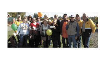 Representatives of the Marysville School District are flanked by members of the Marysville Noon Rotary as they show off their checks from “Pumpkins for Literacy” at the Smokey Point Plant Farm Oct. 25.