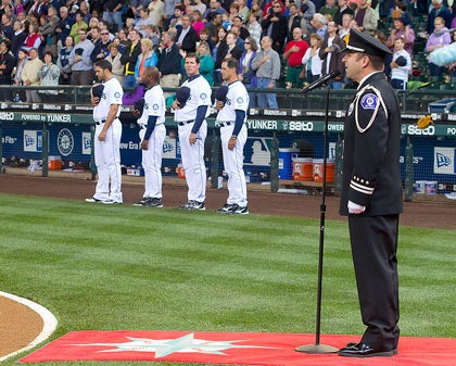 Marysville Firefighter Keith Davis belts out the National Anthem at Safeco Field before the Mariners took on the Kansas City Royals