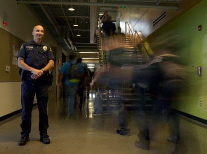 Marysville Police School Resource Officer Dave White maintains a stable presence in the rush of students at the new Marysville Getchell High School.