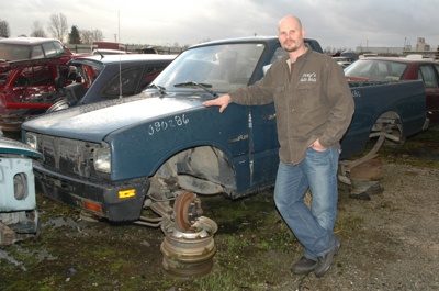 Tim Covey of Covey's Auto Parts in Marysville shows off one of the roughly 50 Isuzu and Suzuki vehicles in his lot with which car owners can trade their own parts to help support local charities.