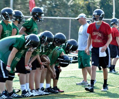 Members of the Marysville Getchell High School varsity football team rest while training for their upcoming season