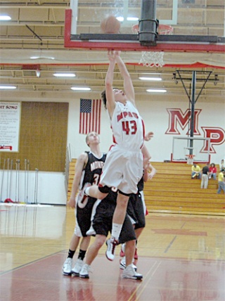 Freshman Ryan Shannon scores two of his first varsity points on an assist from senior guard Ryan Lanphere.