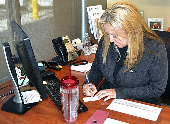 Erin Reynolds works in her office at Coastal Community Bank in Marysville.