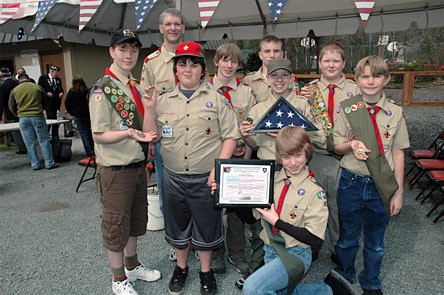 Members of Marysville Boy Scouts of America Troop 419 proudly brandish their brigade coins and flag from Robert Prosser