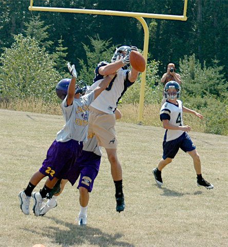 Arlington sophomore Bo Brummel makes a grab for a pass as the team takes on Issaquah.
