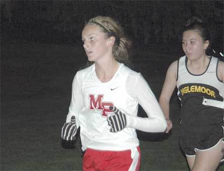 Farrah Bradley makes a move uphill through the dark during the second mile of the Tomahawk Twilight.