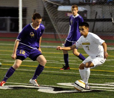 Charger captain Christian Fuerte looks to pass during the April 19 home game against Oak Harbor.