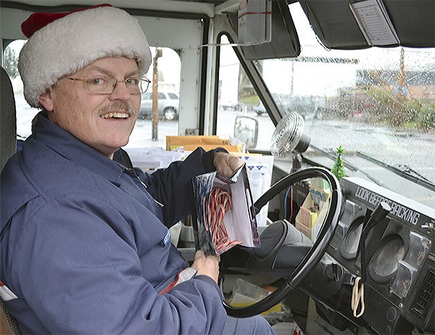 Don Blomdahl delivers more than the mail during the holidays. He gives candy canes to kids in his mail truck that features colorful lights and a miniature Christmas tree.