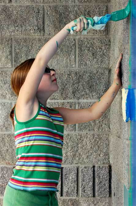 Allen Creek Elementary student Ani Bleakley paints trim around a door Aug. 29.