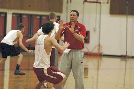 Marysville-Pilchuck coach Bary Gould puts his players through a close-out drill during practice.