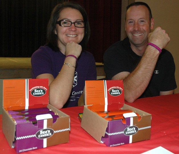 Deanna Sheldon and Doug Wilson hold up their wristbands for 'Leah's Dream Foundation.'