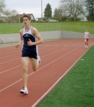 Arlington sophomore James Clark pulls ahead of a Snohomish athlete in the second-to-last lap of the 3