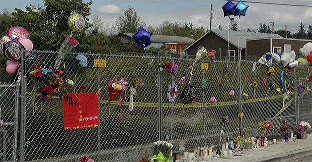 A fence at the site of the deadly crash is now decorated with balloons