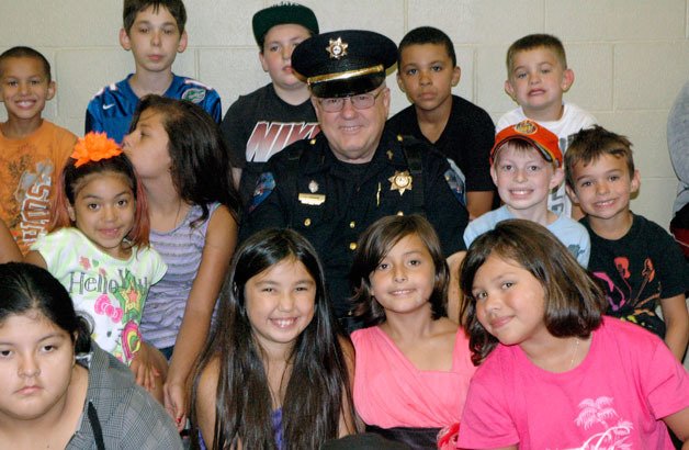 Tulalip Tribal Police Officer Larry Groom meets with the kids of the Tulalip Boys & Girls Club one last time