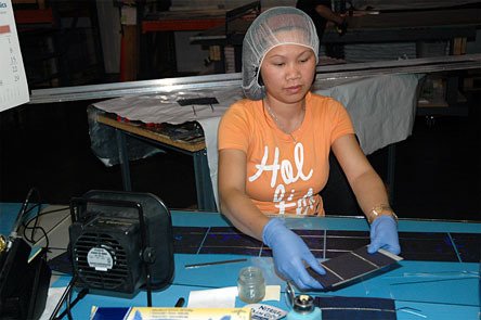 Phallin Luy assembles components for Silicon Energy's solar panels May 20.