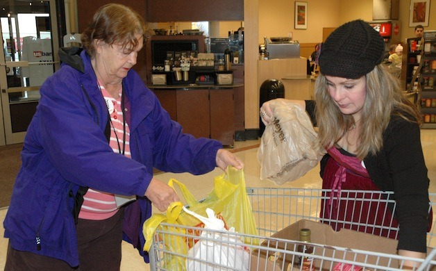 Pat Olson and April O'Brien sort donations of food at the Marysville Fred Meyer Nov. 1.