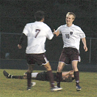 Senior Steve Bingham and junior Joseph Hawkins celebrate Bingham’s goal as time runs out on the Red Raiders.
