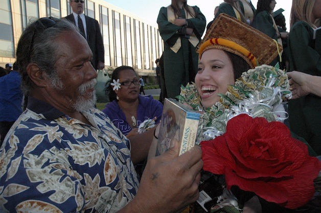 Carlton Aranda drapes a lei around the neck of School for the Entrepreneur graduate Sydney Napeahi during the June 10 commencement for the Marysville Getchell High School Class of 2013.