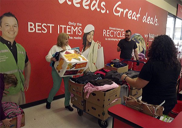 Angel Metcalf of Pregnancy Aid lifts a box of clothes donated to the organization from the Value Village in Marysville.