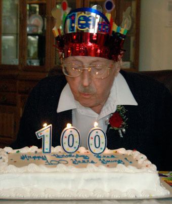 Fred Teachout blows out the candles for his 100th birthday cake at Windsor Square Senior Apartments on June 24.