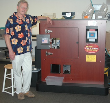 Marysville Tobacco Joes Manager Dennis Stanley shows off the roll-your-own filling station machine that allows customers to roll 200 cigarettes within 10 minutes.