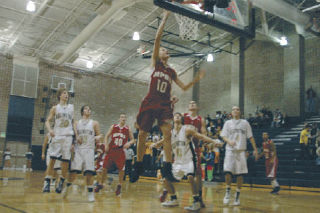 M-P senior Tyler Holm drives to the basket. Holm led the Tomahawks with 11 points.