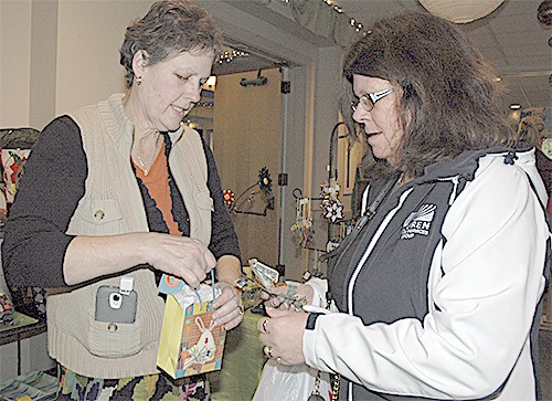 Vendor Cindy Martinez sells gift items to Laurie Nest.