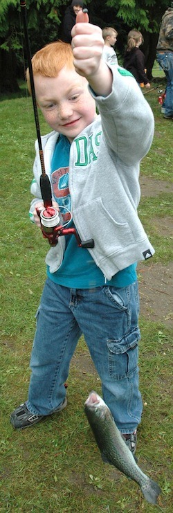 Jrake Meier of Marysville shows off the trout he caught.
