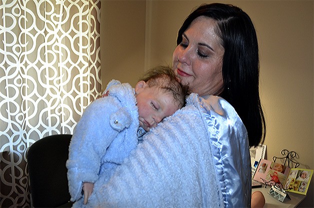 Laura Berry holds Kyle. She's been told he's the most lifelike doll she's made. She said she gets her 'baby fix' by making the dolls.