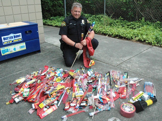 Marysville Police Officer Ray Riches displays some of the illegal fireworks that were confiscated in the city in the wake of this year’s Fourth of July.