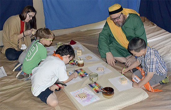 Word of Life Pastor Jay Price dresses the part as he works with youngsters at the Vacation Bible School at his church July 14.