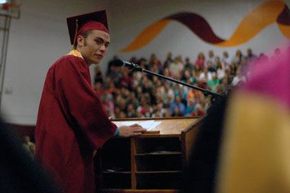Class speaker Mark Fernandez looks back at faculty speaker Terry Keffer before giving his speech.