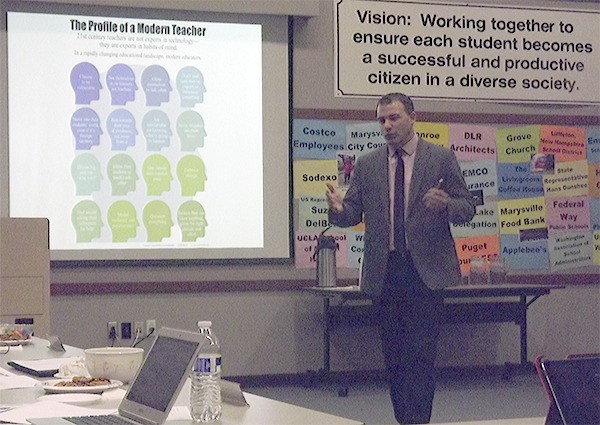 Jeff Utecht of eduro shows his company's PowerPoint to school officials in Marysville. The firm trains teachers in digital instruction methods.