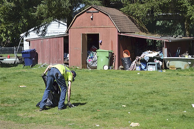 A man known only as 'Dre' died of a drug overdose last year in this barn behind the Buck house. City workers were on the property March 31 cleaning up and boarding up the home.