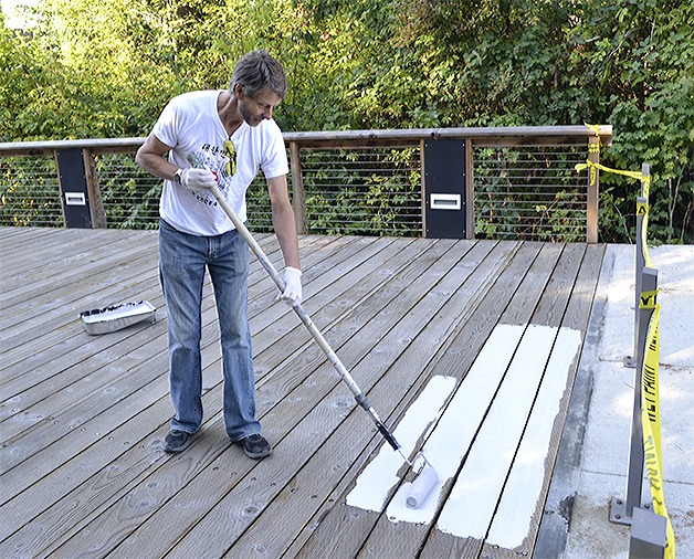 Troy Tucker paints a bridge at Marysville Getchell High School.