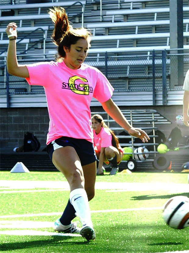 Arlington's Danielle Baker practices her passing during a soccer practice.