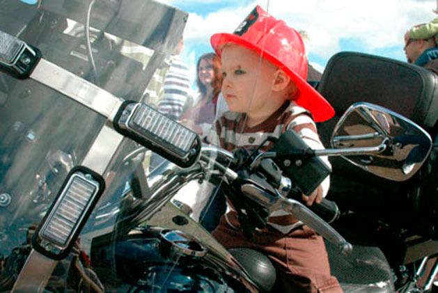 Two-year-old Aiden Zacky of Marysville sits on a police motorcycle during last year's “Touch a Truck” event at Asbery Field.
