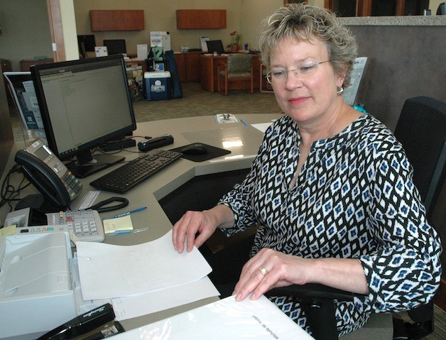 Customer service representative Michelle Wetzel reviews a client's paperwork at the new Marysville branch of Coastal Community Bank.