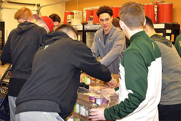 Cameron Burns and his Marysville Getchell High School boys basketball teammates volunteer at the Marysville Food Bank Saturday.