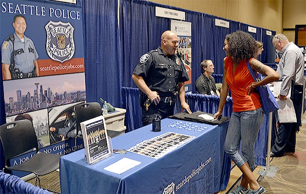 Detective Andre Sinn of the Seattle Police Department talks about the application process during the Snohomish County Career Fair at the Tulalip Resort Casino Sept. 10.