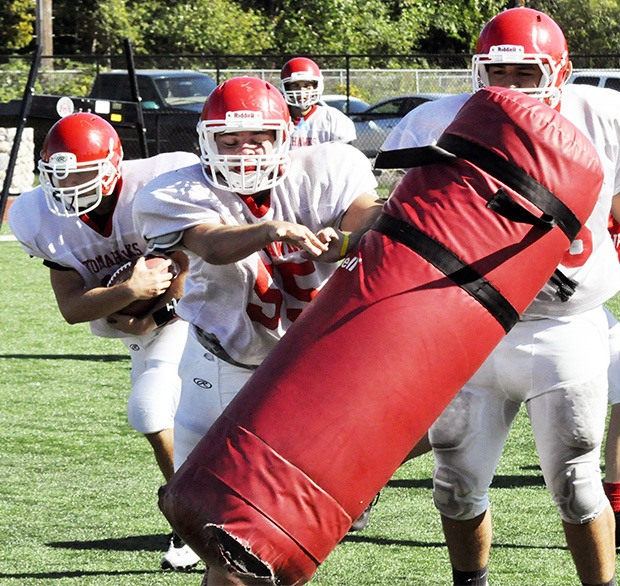 The Marysville-Pilchuck football team's offensive line runs a play during a drill.