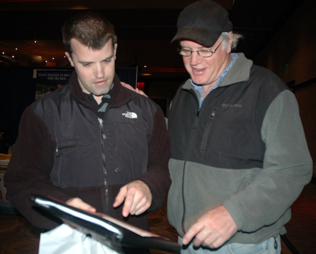 Jacob Simmons looks over a brochure with his dad Roger.