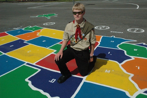 William Schamp shows off the repainted map of the United States