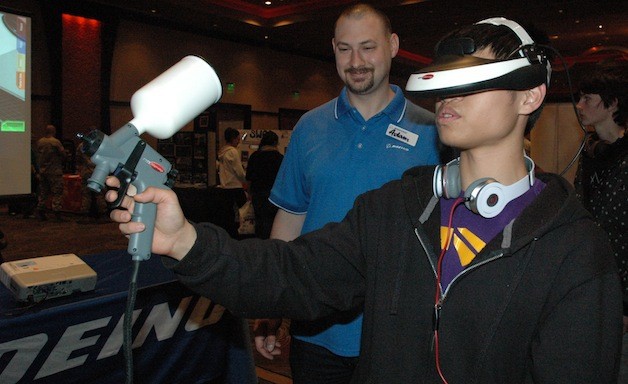 Boeing’s Adam Bursell guides Lakewood High School junior Stanley Wung through a virtual painting exercise during the Marysville School District’s Opportunity Expo on April 22.